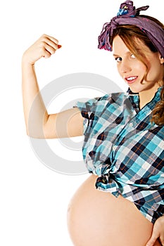 Young pregnant woman showing arm muscles