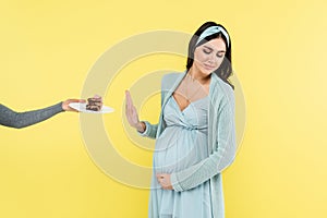young pregnant woman showing reject gesture
