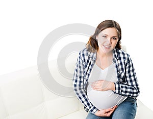 Young pregnant woman on a sofa