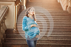 Young pregnant woman on the steps.