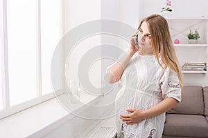 Young pregnant woman talking on her smartphone