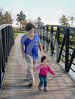 Young pregnant woman and toddler daughter