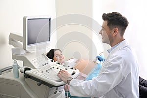 Young pregnant woman undergoing ultrasound scan