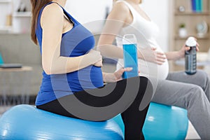 young pregnant women with water doing exercises