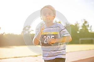 Young preschool children, running on track in a marathon competition