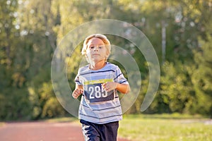 Young preschool children, running on track in a marathon competition