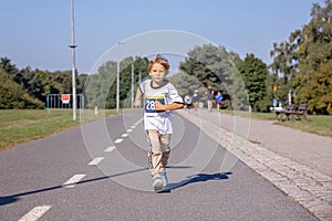 Young preschool children, running on track in a marathon competition