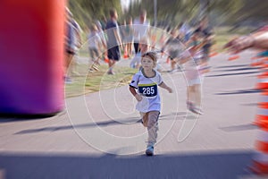 Young preschool children, running on track in a marathon competition