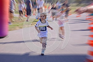 Young preschool children, running on track in a marathon competition