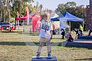 Young preschool children, running on track in a marathon competition