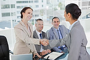 Young pretty applicant shaking hands with future employers