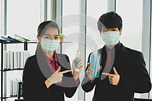The young pretty Asian employee wearing face mask for COVID-19 virus pandemic  prevention