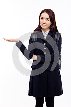 Young pretty Asian student indicate side space