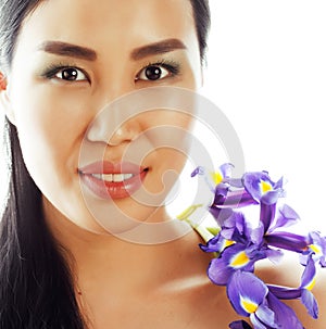 Young pretty asian woman with flower orchid close up isolated sp