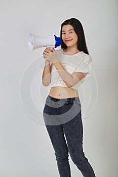 Young pretty Asian woman holding megaphone