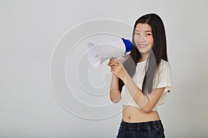 Young pretty Asian woman holding megaphone