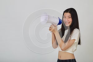 Young pretty Asian woman holding megaphone