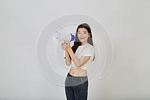 Young pretty Asian woman holding megaphone