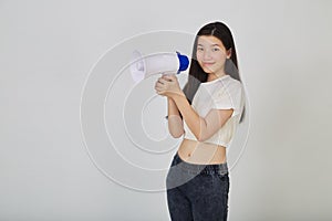 Young pretty Asian woman holding megaphone