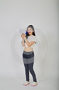 Young pretty Asian woman holding megaphone