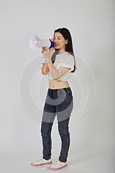 Young pretty Asian woman holding megaphone