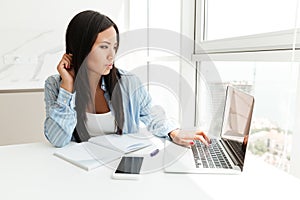 Young pretty asian woman working with laptop