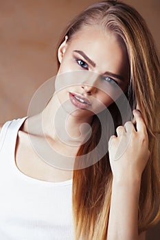 Young pretty blond woman with fresh natural makeup posing cheerful on browm background, lifestyle people concept