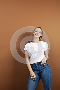 Young pretty blond woman with fresh natural makeup posing cheerful on browm background, lifestyle people concept