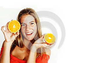 Young pretty blond woman with half oranges close up on