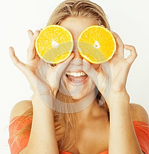 Young pretty blond woman with half oranges close