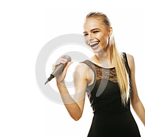 Young pretty blond woman singing in microphone isolated close up