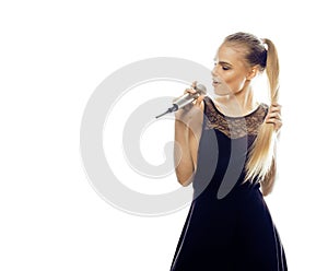 Young pretty blond woman singing in microphone isolated close up