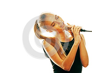 Young pretty blond woman singing in microphone isolated close up