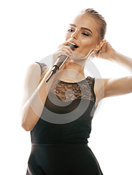 Young pretty blond woman singing in microphone