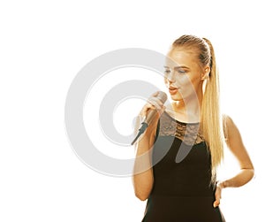 Young pretty blond woman singing in microphone isolated close up karaoke