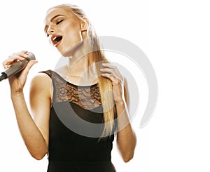 Young pretty blond woman singing in microphone isolated close up karaoke