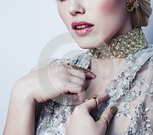 Young pretty blond woman wearing lot of luxury rich jewelry and fashion style makeup, lifestyle beauty people concept