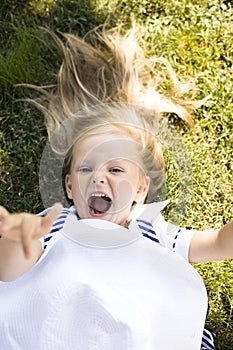 Young pretty blonde girl in park smiling