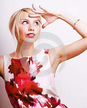 Young pretty blonde girl presenting something at white copy space, emotional posing, lifestyle people concept