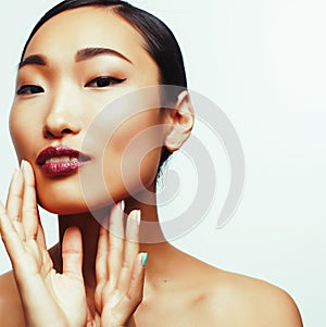 young pretty brunette asian woman emotional posing, happy smiling isolated on white background, lifestyle spa cosmetic
