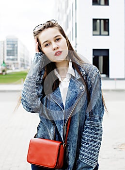 Young pretty brunette business woman posing against modern building in hat holding coffee, lifestyle people concept