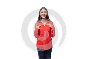 young pretty brunette caucasian model woman dressed in fashionable red shirt tells interesting news on white background