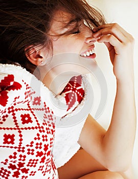 Young pretty brunette girl in Christmas ornament blanket getting