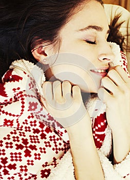 Young pretty brunette girl in Christmas ornament blanket getting