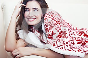 Young pretty brunette girl in Christmas ornament blanket getting warm on cold winter, freshness beauty concept
