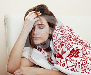 Young pretty brunette girl in Christmas ornament blanket getting warm on cold winter, freshness beauty concept