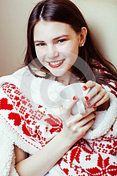 Young pretty brunette girl in Christmas ornament blanket getting warm on cold winter, freshness beauty concept