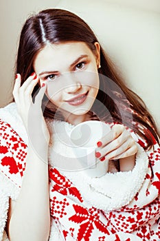 Young pretty brunette girl in Christmas ornament blanket getting warm on cold winter, freshness beauty concept