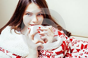 Young pretty brunette girl in Christmas ornament blanket getting warm on cold winter, freshness beauty concept