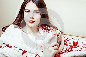 Young pretty brunette girl in Christmas ornament blanket getting warm on cold winter, freshness beauty concept